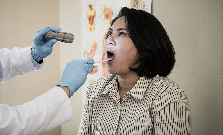Woman getting dental exam - Developmental Dentistry