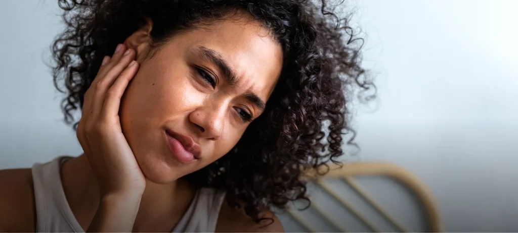 Woman suffering from TMJ pain - Developmental Dentistry